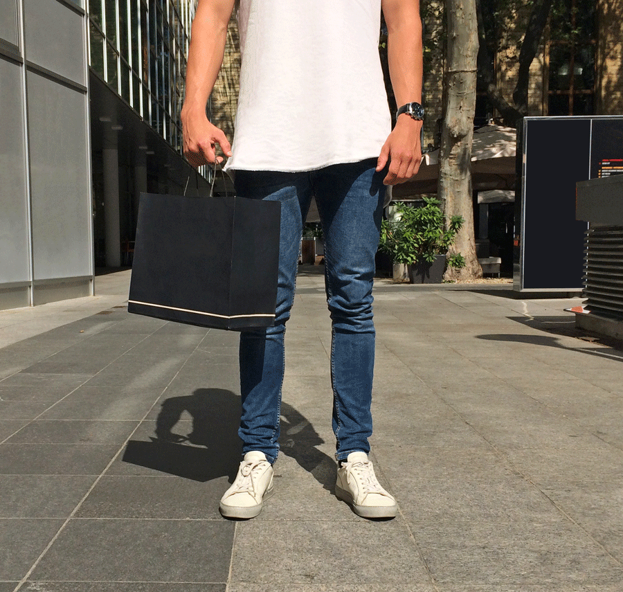 mystery shopper standing with a bag